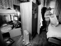 Nayy veterans and roomates, Mike Silvia, left, prepares to put away a puzzle he has recently completed while Steve Viveiros, right, gets ready to do laundry, inside their shared room at the Veterans Transition House in New Bedford which is currently located inside the former rectory of the St John the Baptist church on County Street in New Bedford.  The church, which was the first Portuguese catholic church in the United States, has been unoccupied since 2012.   PHOTO PETER PEREIRA